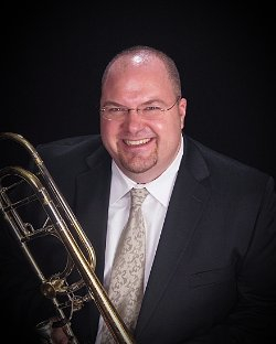 Color photo of David Begnoche holding a trombone