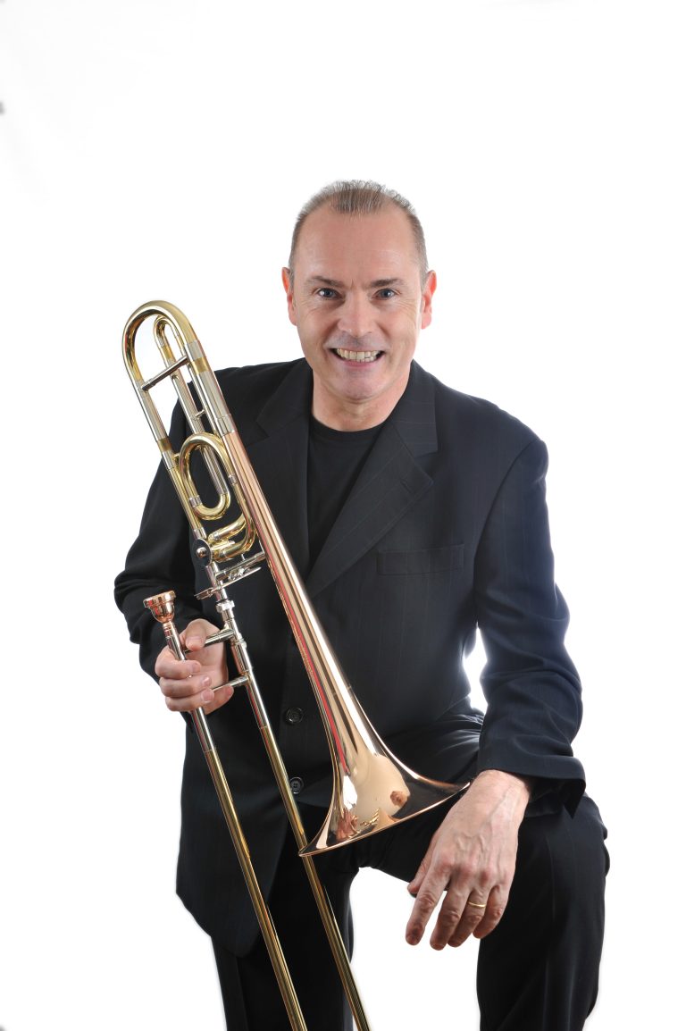 Jacques Mauger holding a trombone