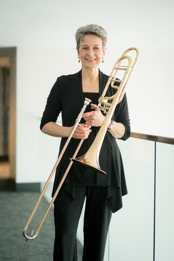 JoDee Davis holding a trombone