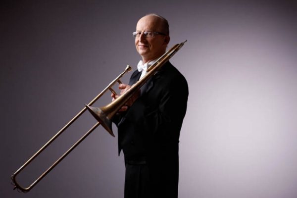 jay friedman holding a trombone